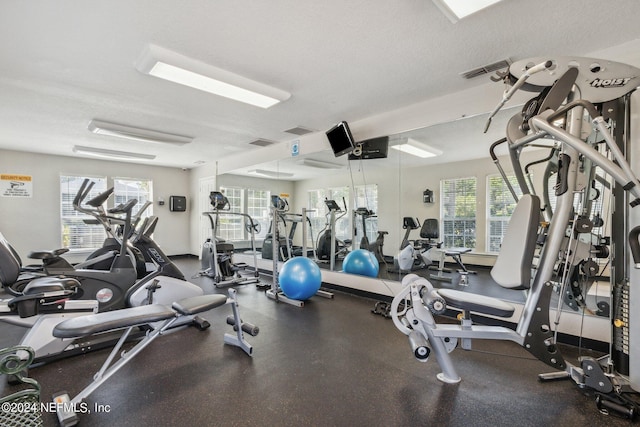 workout area featuring visible vents and a textured ceiling