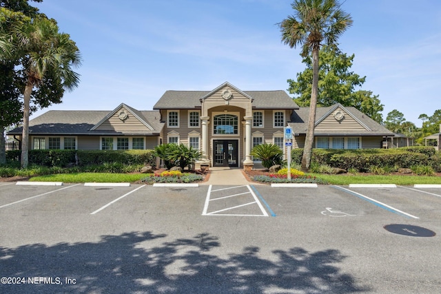 view of building exterior featuring uncovered parking