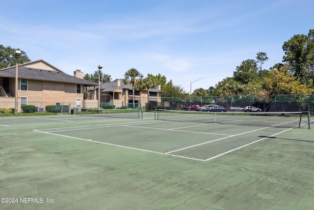 view of tennis court with fence