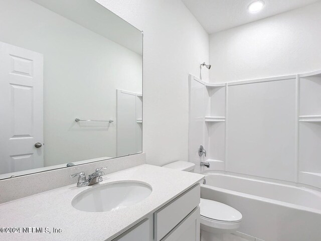 full bathroom featuring shower / bathtub combination, vanity, and toilet