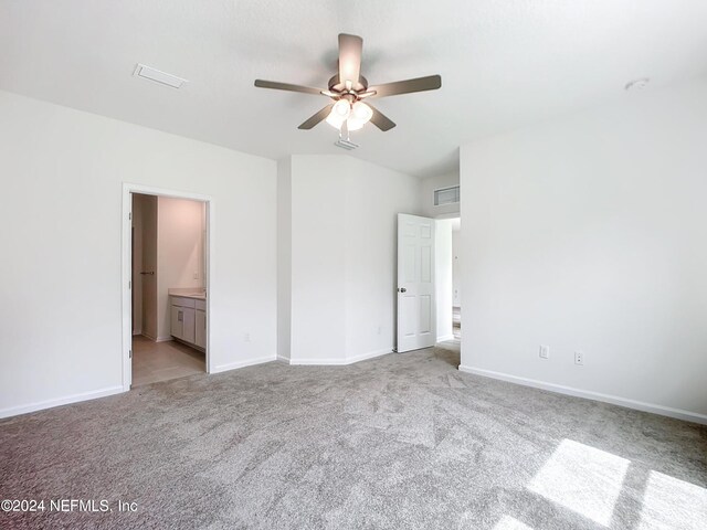 carpeted spare room with ceiling fan