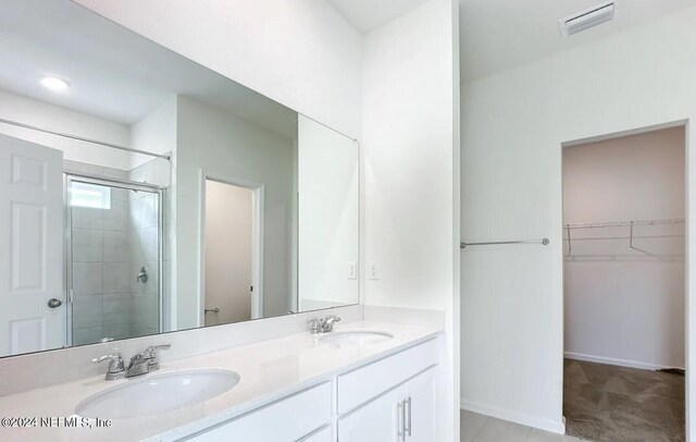 bathroom with vanity, walk in shower, and tile patterned floors