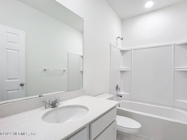 bathroom with bathing tub / shower combination, toilet, and vanity