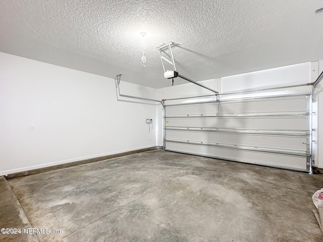 garage with a garage door opener and baseboards