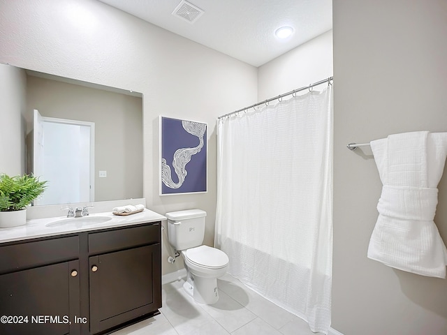 bathroom with visible vents, toilet, tile patterned flooring, shower / bath combo with shower curtain, and vanity