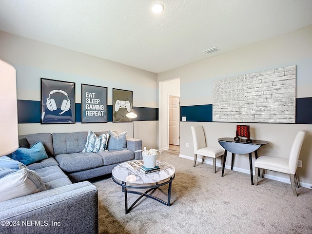 carpeted living room featuring baseboards, visible vents, and a textured ceiling