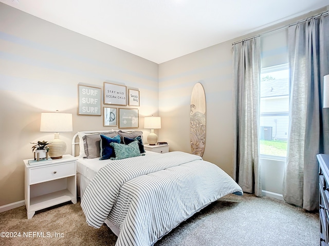 bedroom with carpet floors and baseboards