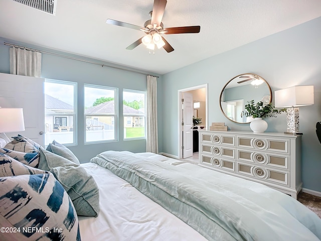 bedroom featuring baseboards, visible vents, and a ceiling fan