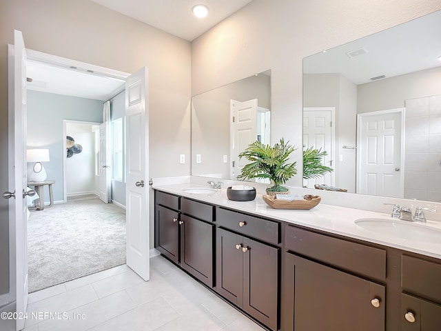 full bathroom with double vanity, visible vents, a sink, and tile patterned floors