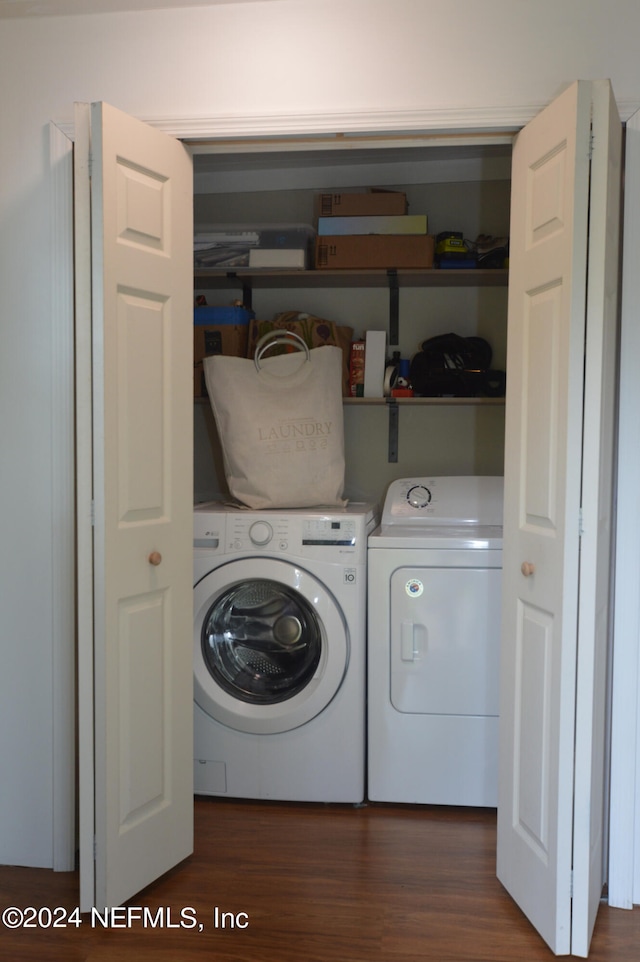 laundry area with dark hardwood / wood-style flooring and separate washer and dryer