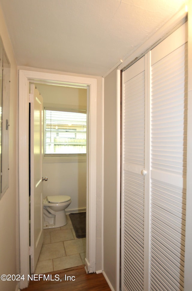 bathroom with toilet and tile patterned floors