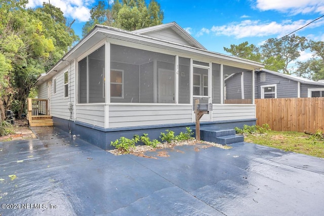 view of front of house featuring a sunroom