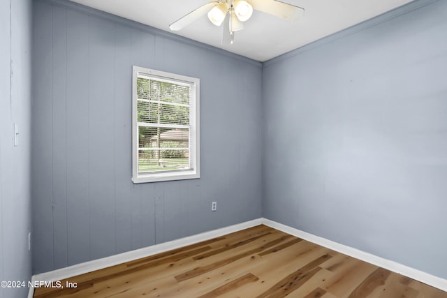 spare room featuring ceiling fan, ornamental molding, and hardwood / wood-style flooring