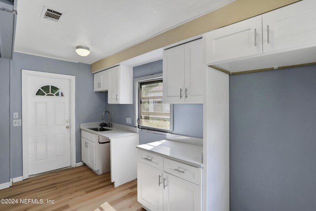 kitchen with sink, white cabinetry, and light hardwood / wood-style floors