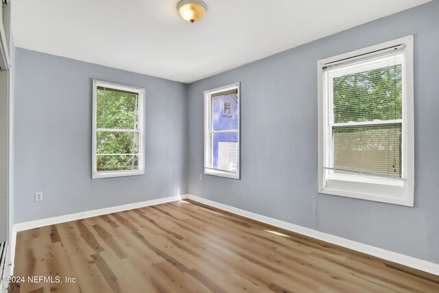 spare room featuring hardwood / wood-style floors