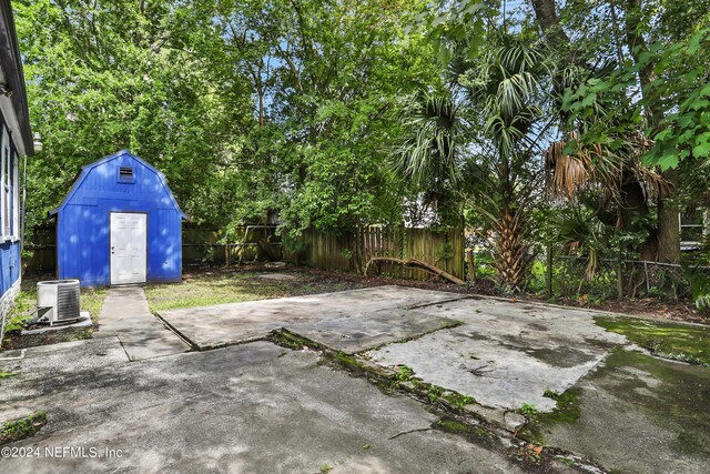 view of patio / terrace featuring a storage shed and central AC unit