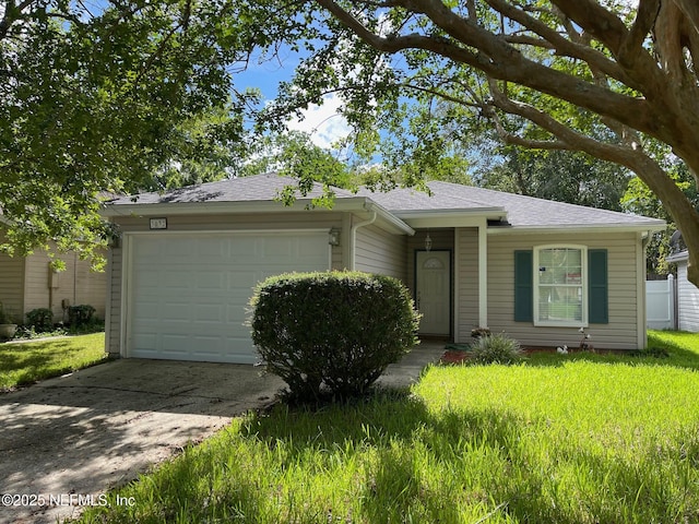 ranch-style house with a garage and a front lawn