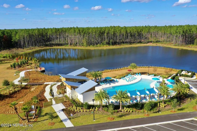 bird's eye view with a water view and a wooded view