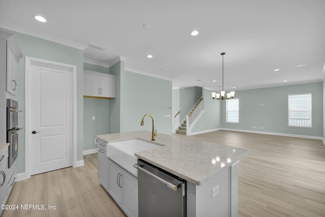 kitchen featuring light stone countertops, light wood-style floors, and stainless steel appliances