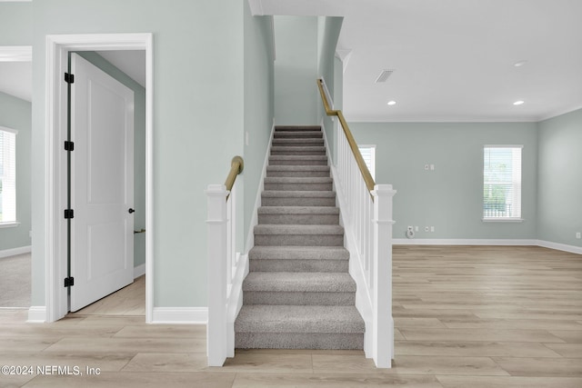 stairway with recessed lighting, baseboards, and wood finished floors