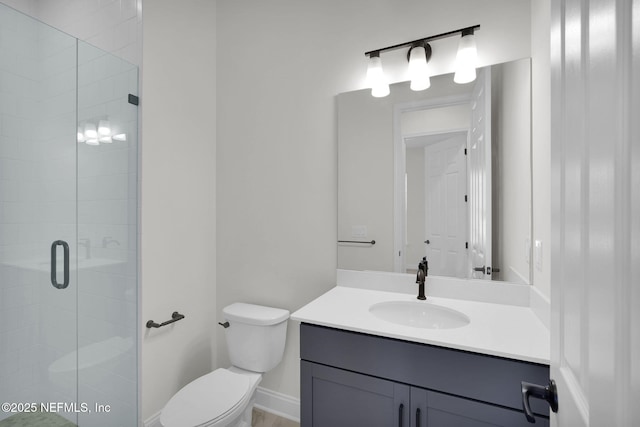 bathroom with vanity, an enclosed shower, and toilet