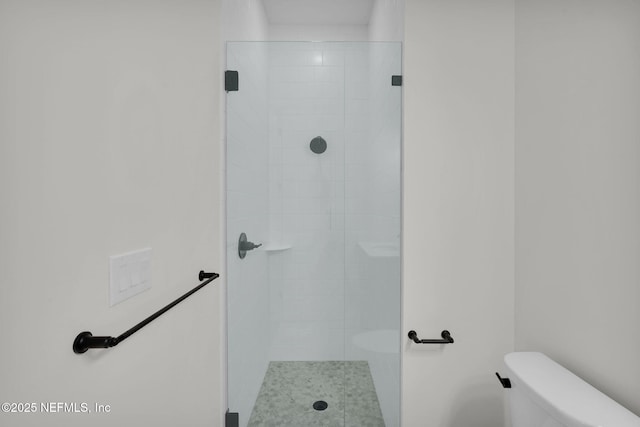 bathroom featuring toilet and walk in shower