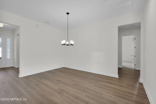 unfurnished dining area with dark wood-type flooring and a chandelier