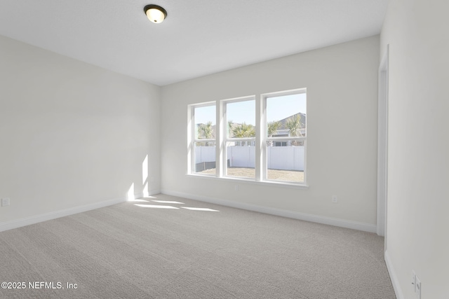 unfurnished room with light carpet