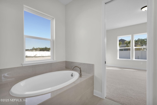 bathroom with a relaxing tiled tub