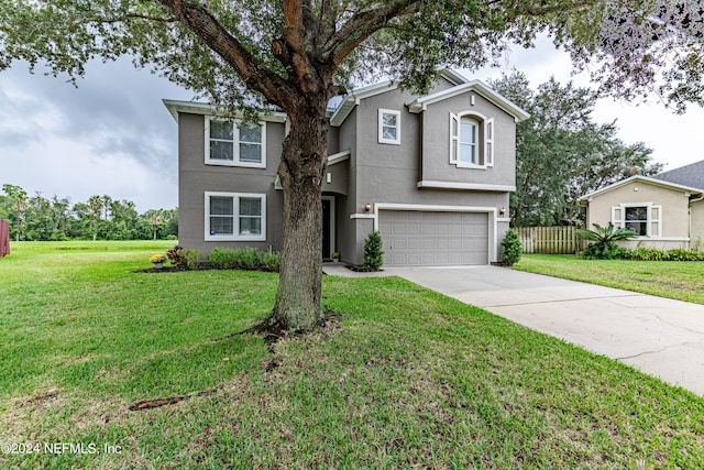 front of property featuring a garage and a front lawn