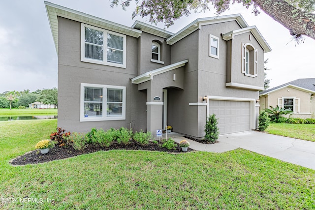 view of front of home with a garage and a front lawn