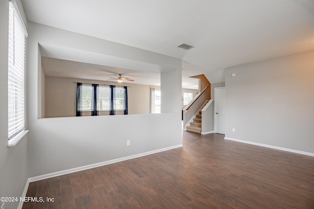 empty room with dark hardwood / wood-style flooring and ceiling fan