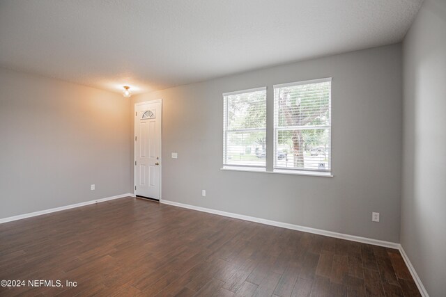 empty room featuring dark hardwood / wood-style flooring