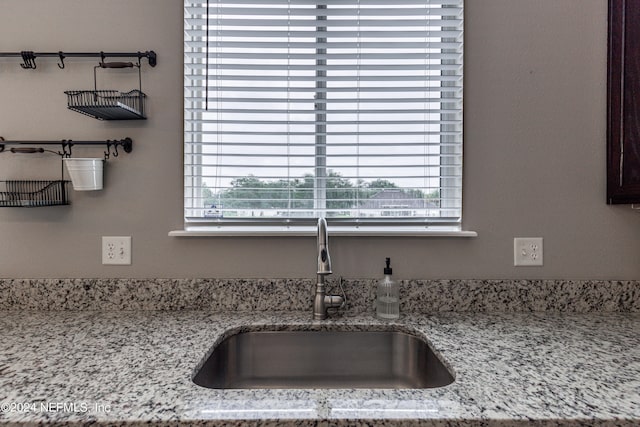 interior details with light stone countertops and sink