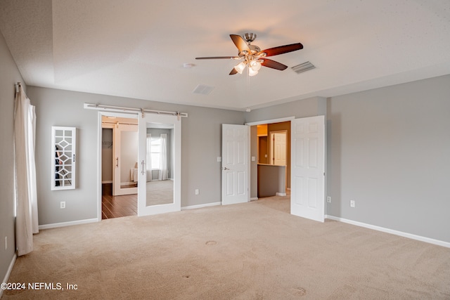 unfurnished bedroom with carpet and ceiling fan