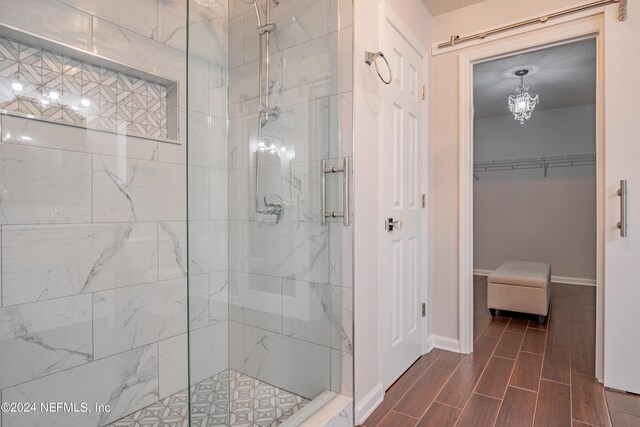 bathroom featuring a shower with shower door