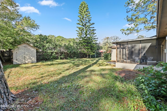 view of yard featuring a sunroom and a storage shed