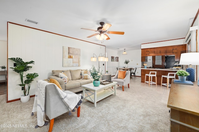 living room with light colored carpet and ceiling fan