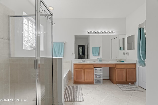 full bath with tile patterned flooring, a sink, a bath, double vanity, and a stall shower