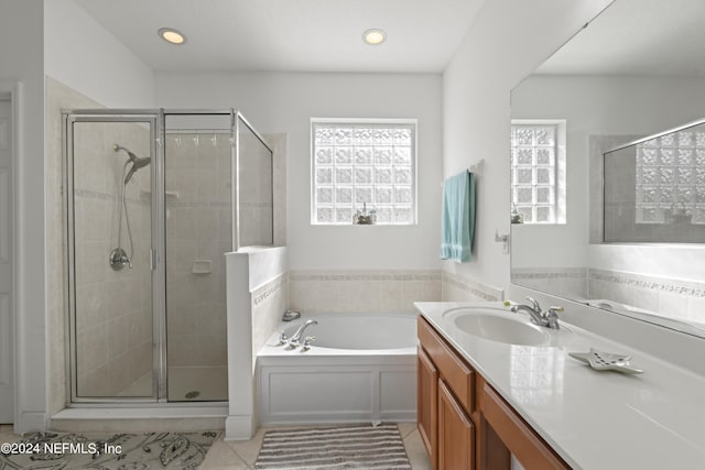 bathroom featuring tile patterned flooring, recessed lighting, vanity, a shower stall, and a bath