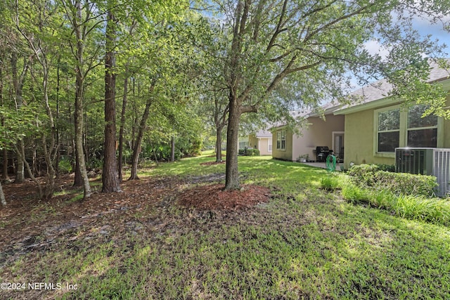 view of yard with central air condition unit