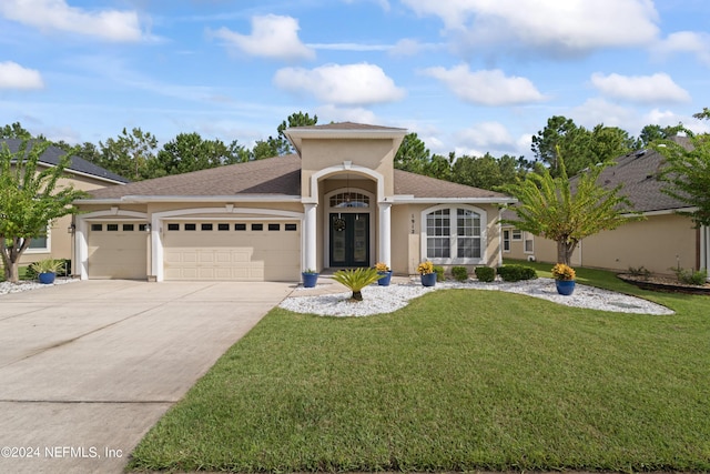 view of front of home featuring an attached garage, a front lawn, concrete driveway, and stucco siding