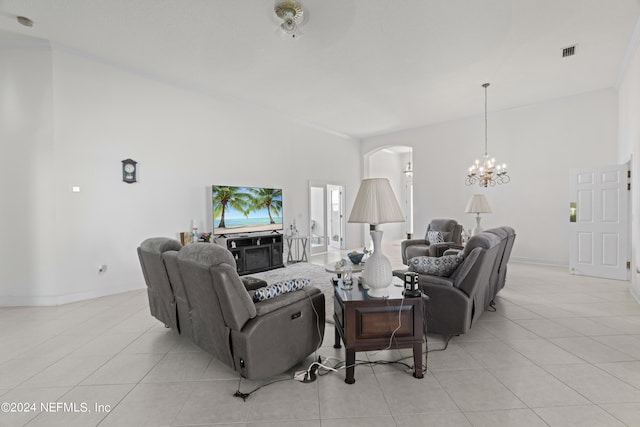 living room featuring arched walkways, light tile patterned floors, visible vents, and a notable chandelier