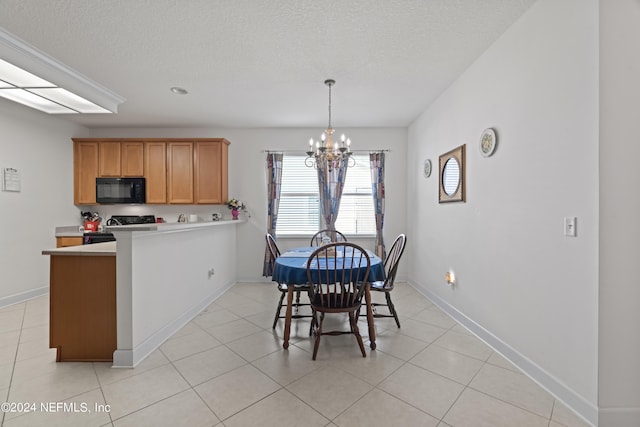 dining space with a textured ceiling, light tile patterned floors, baseboards, and a notable chandelier