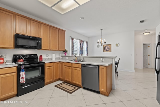 kitchen with pendant lighting, light countertops, visible vents, a sink, and black appliances