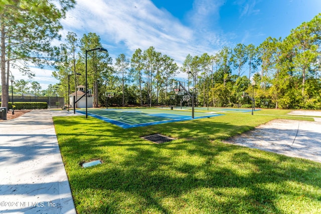 view of sport court featuring a yard, community basketball court, and fence