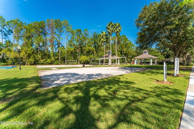 surrounding community with volleyball court, a yard, and a gazebo