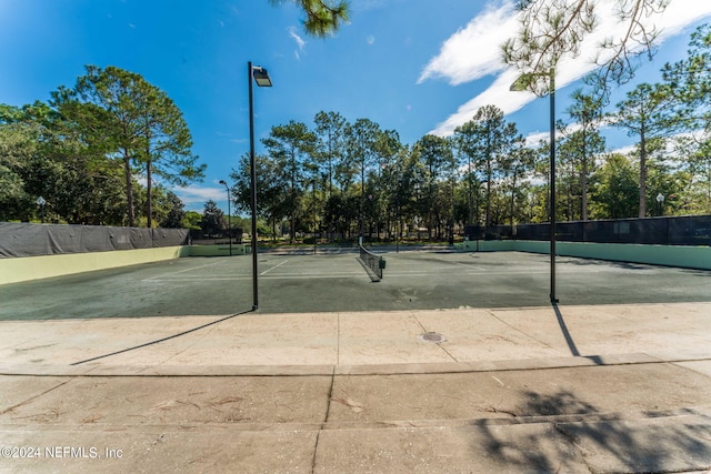 view of tennis court with fence