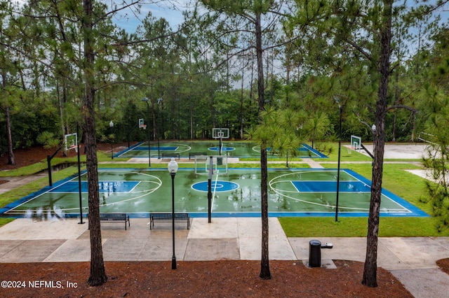 view of basketball court with community basketball court and a lawn