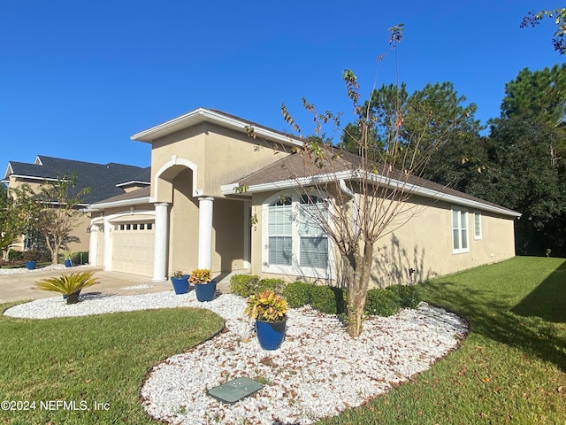 view of front of home featuring a garage and a front lawn